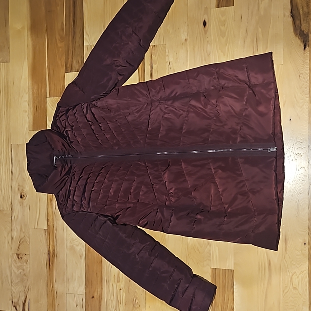 Winter jacket, burgundy color, sits below knees